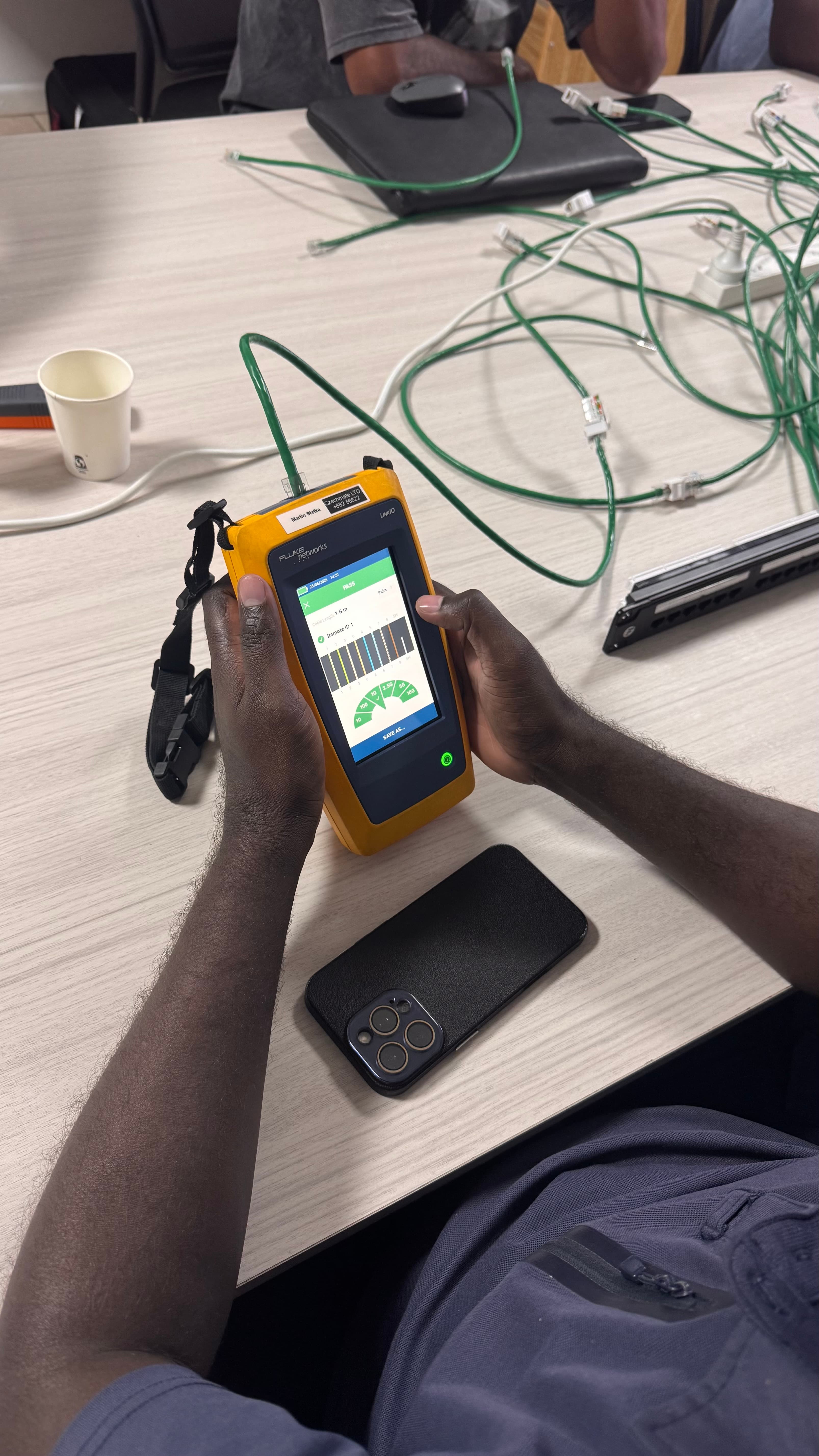 Participant using cable test equipment during a hands-on cabling exercise